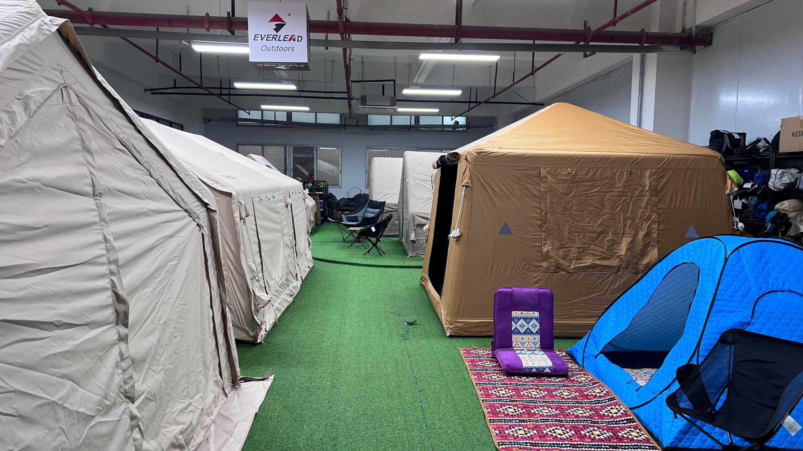 Rooftop tents displayed open and closed in a showroom